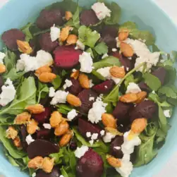 Fresh beetroot salad with arugula, almonds, and crumbled feta cheese, perfect for Fleurieu Food & Wine events.