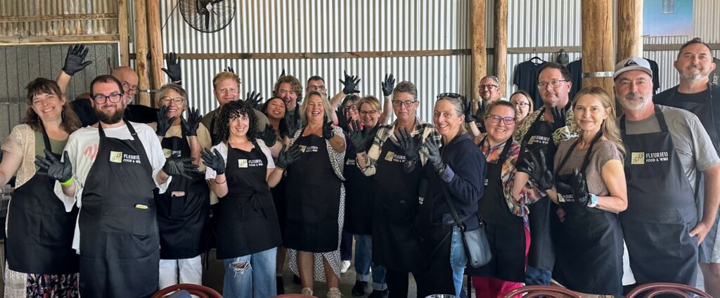 Group of participants smiling during a cooking class at Fleurieu Food & Wine