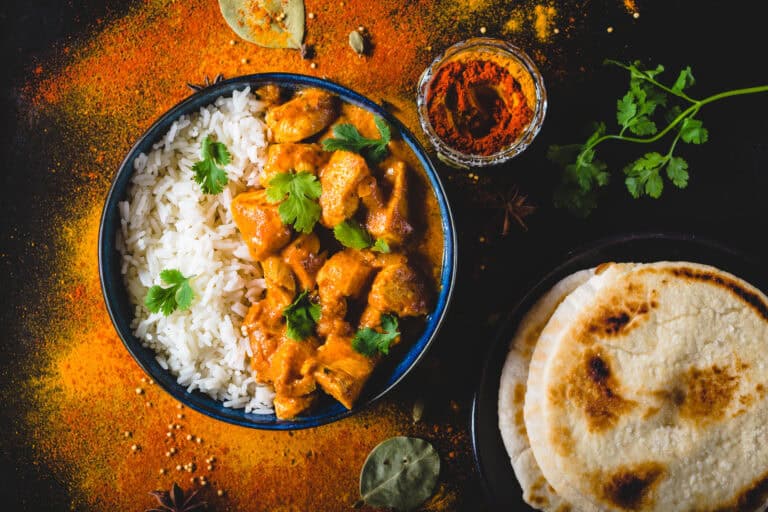 Tandoori Spiced Chicken, rice, naan bread, and spices, showcasing Fleurieu Food & Wine cuisine.