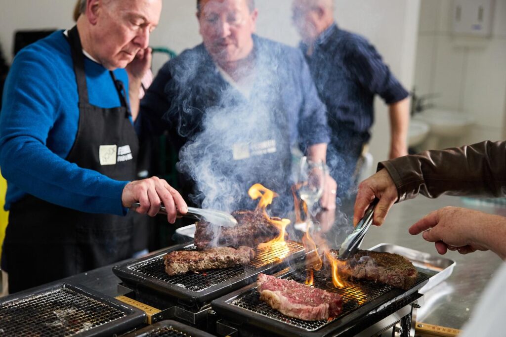 Participants grilling premium Angus beef on hibachi grills during the Hibachi Steak Masterclass at Fleurieu Food & Wine